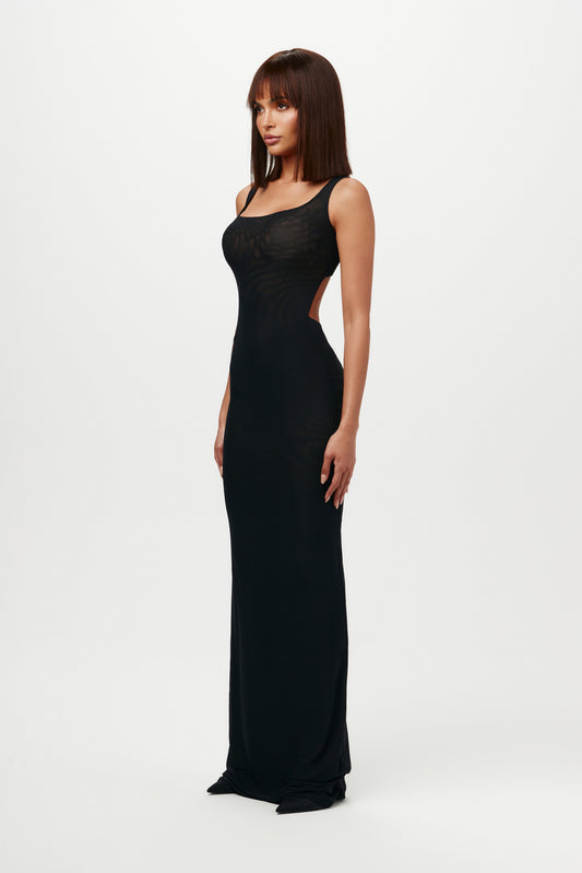 Our sexy maxi-length tank dress traces your curves with a soft scooped neck, open back, and slinky sheer mesh. Minimalist lines translate day or night. Wear with our foundation undergarments for modest coverage.