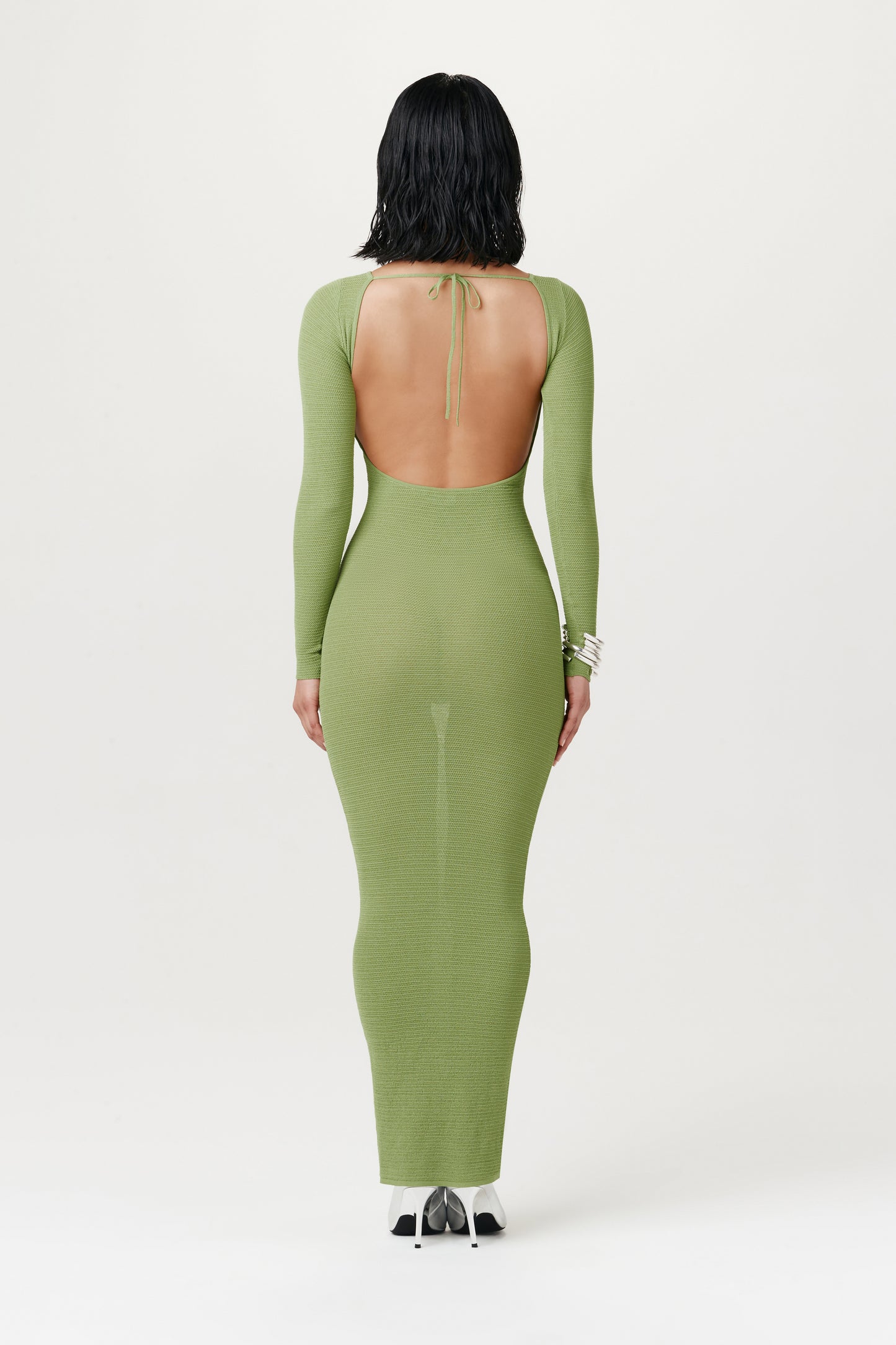 view from behind: woman wearing backless light green maxi dress