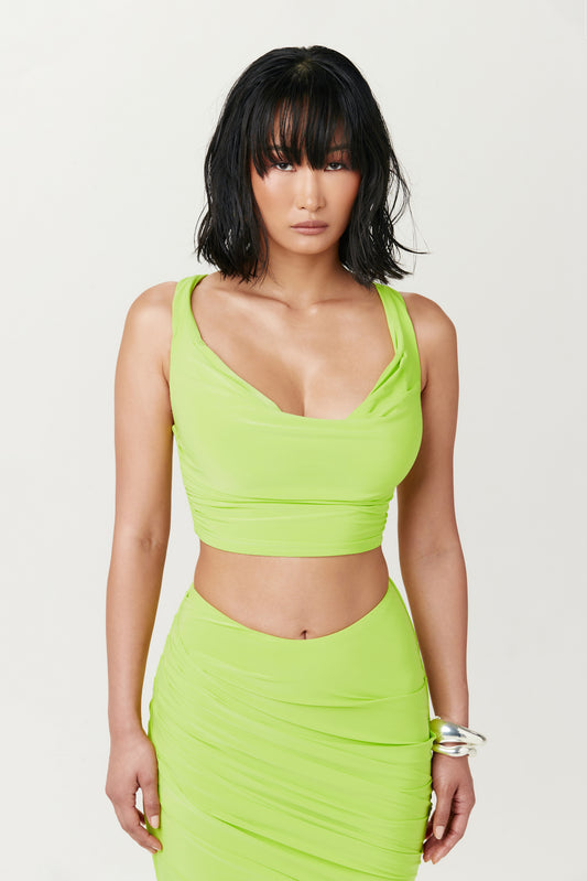 woman wearing lime green crop top and matching skirt
