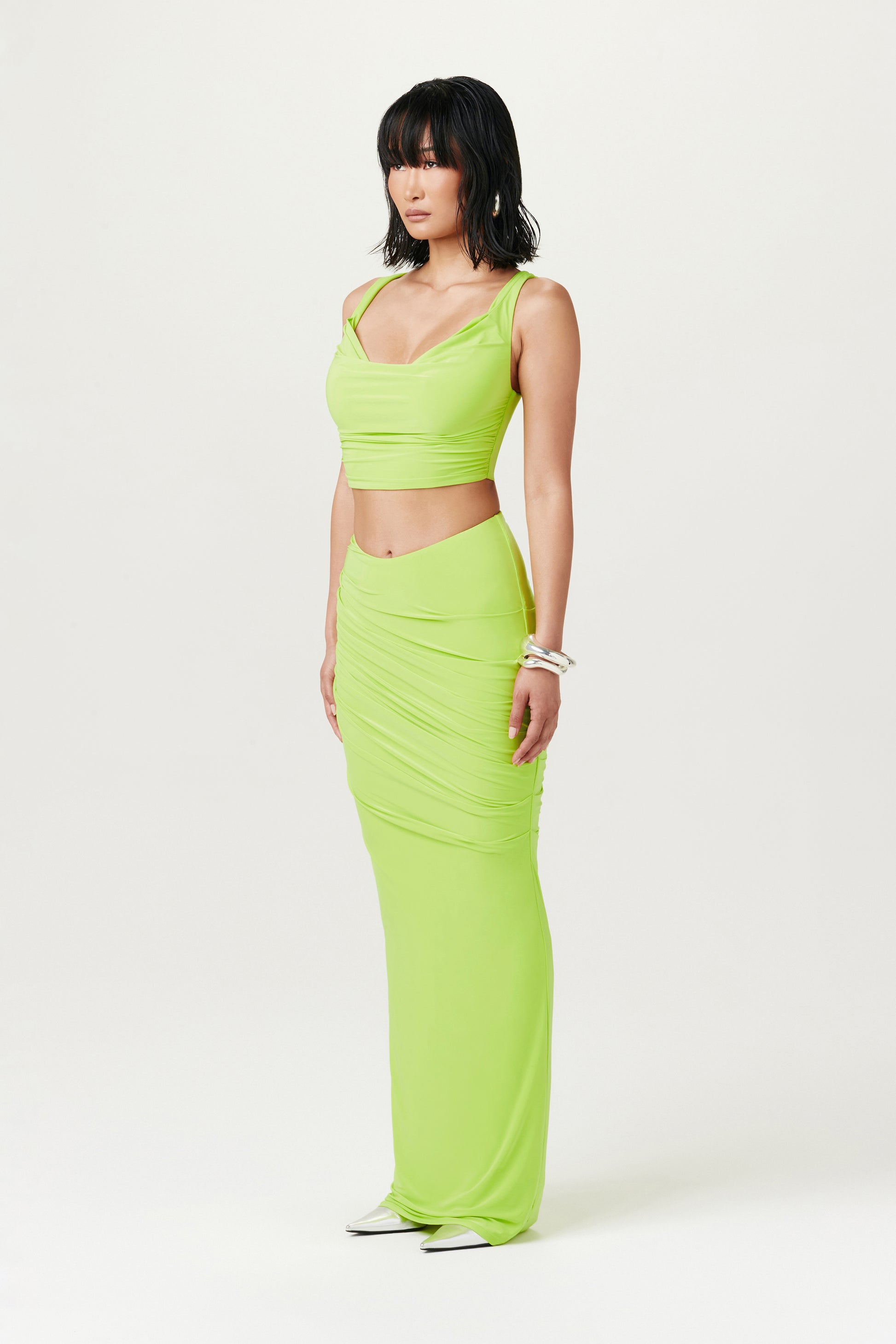 lime green crop cowl top and maxi skirt on woman standing upright
