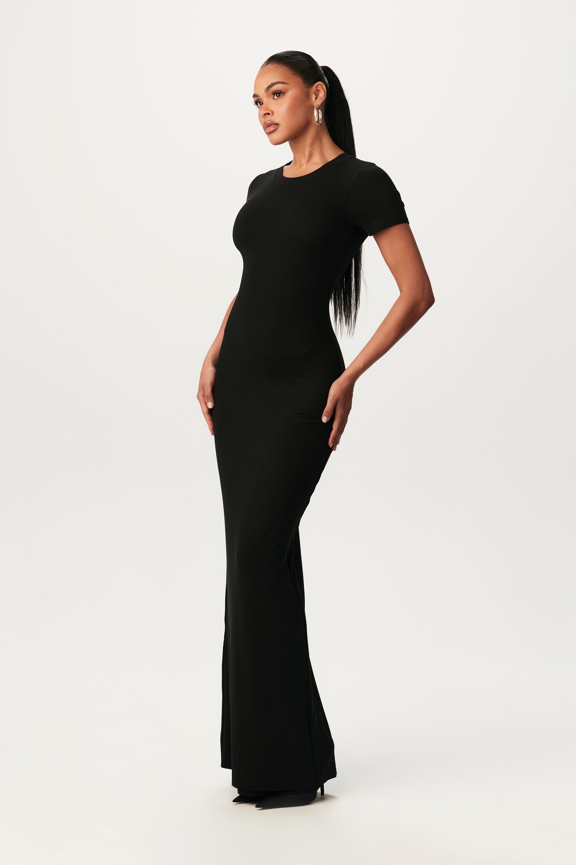 posed, side-view of black, bodycon maxi dress