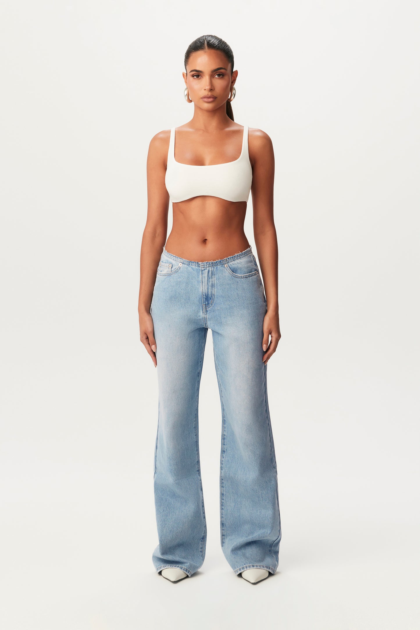 front view of wide-leg jeans and white bra top