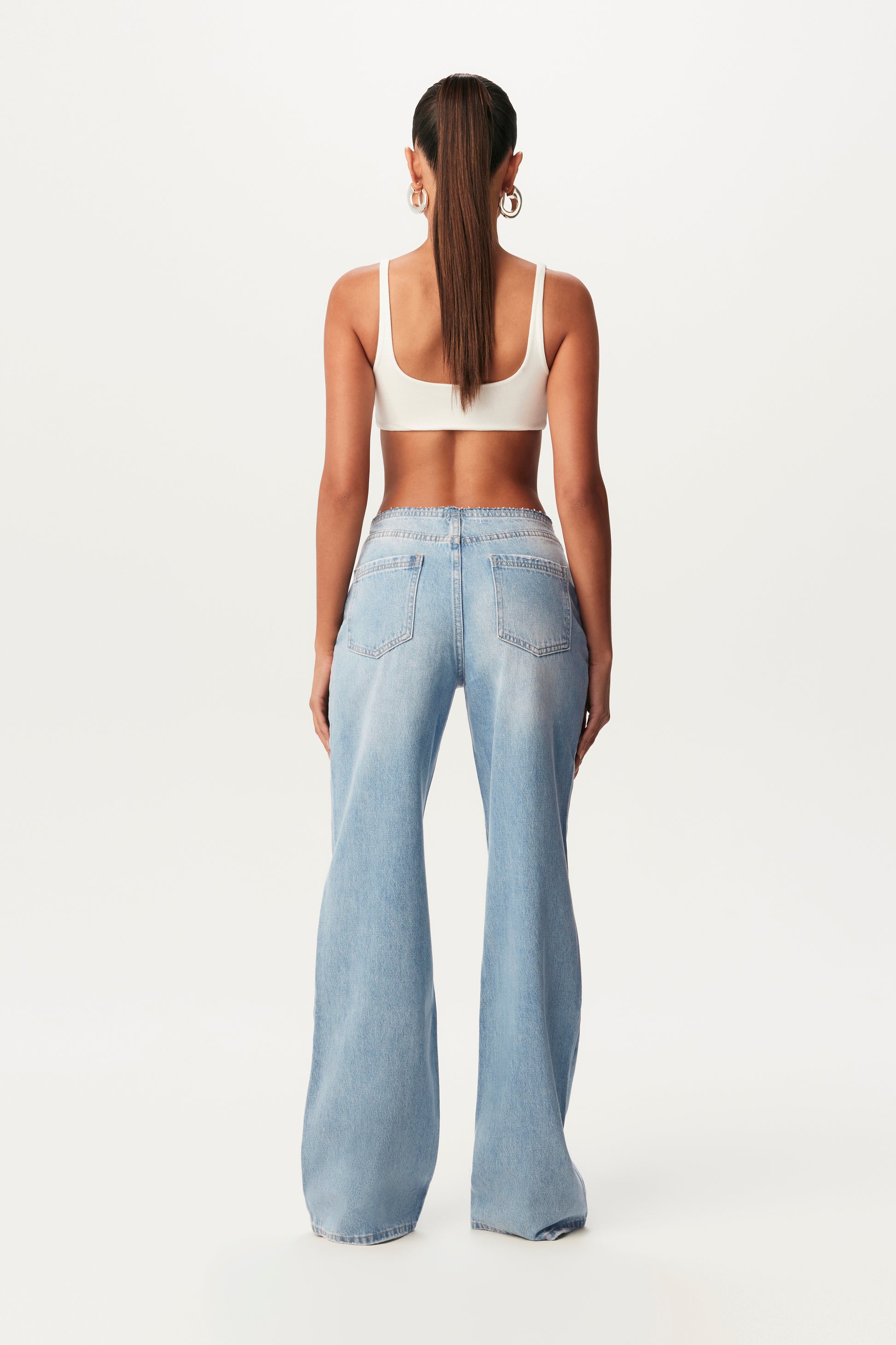 rear view of white ultra-crop top and wide-leg jeans